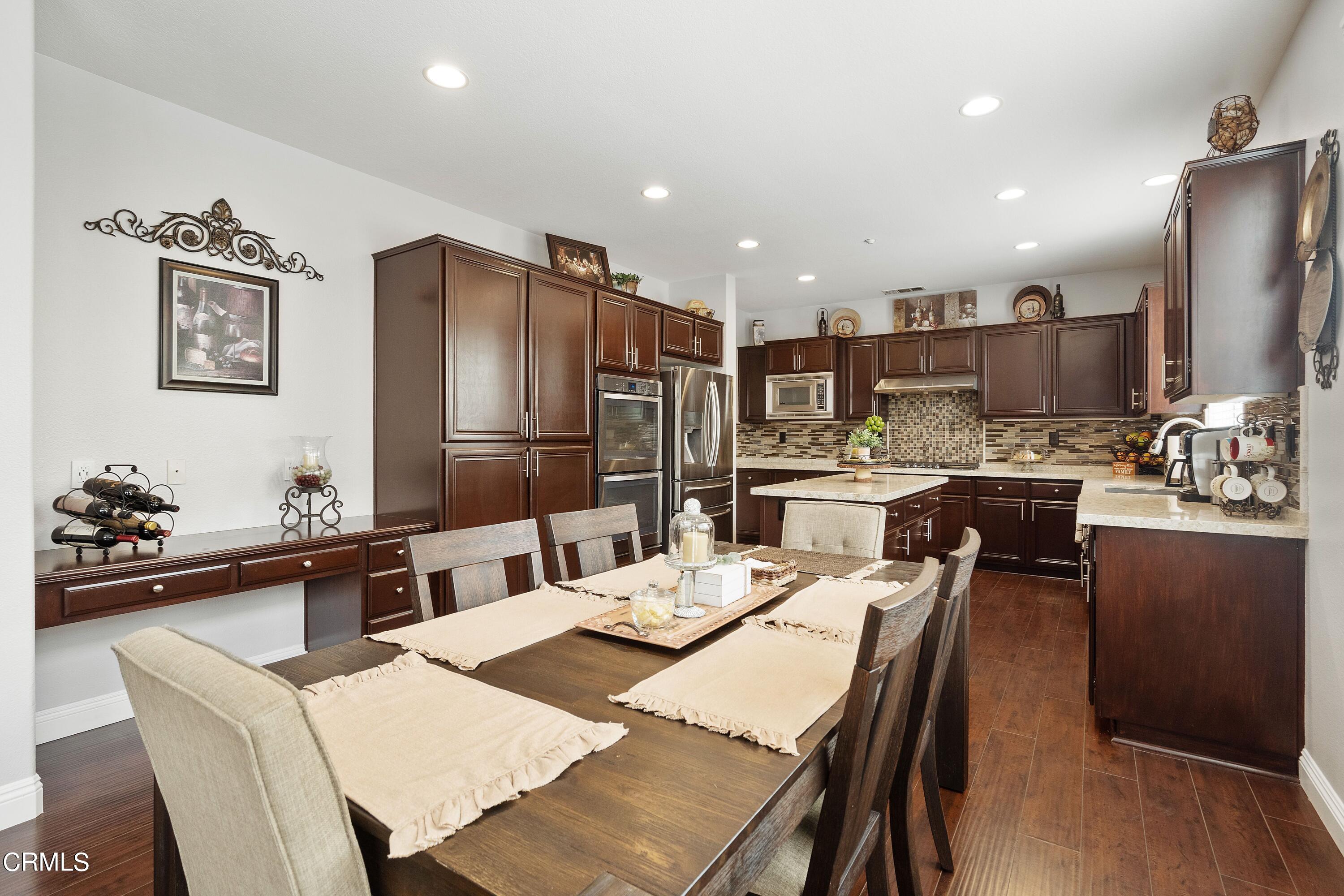 1713 Tiesa Lane Oxnard, CA 93030 - Photo 9 of 48 a kitchen with a dining table and chairs