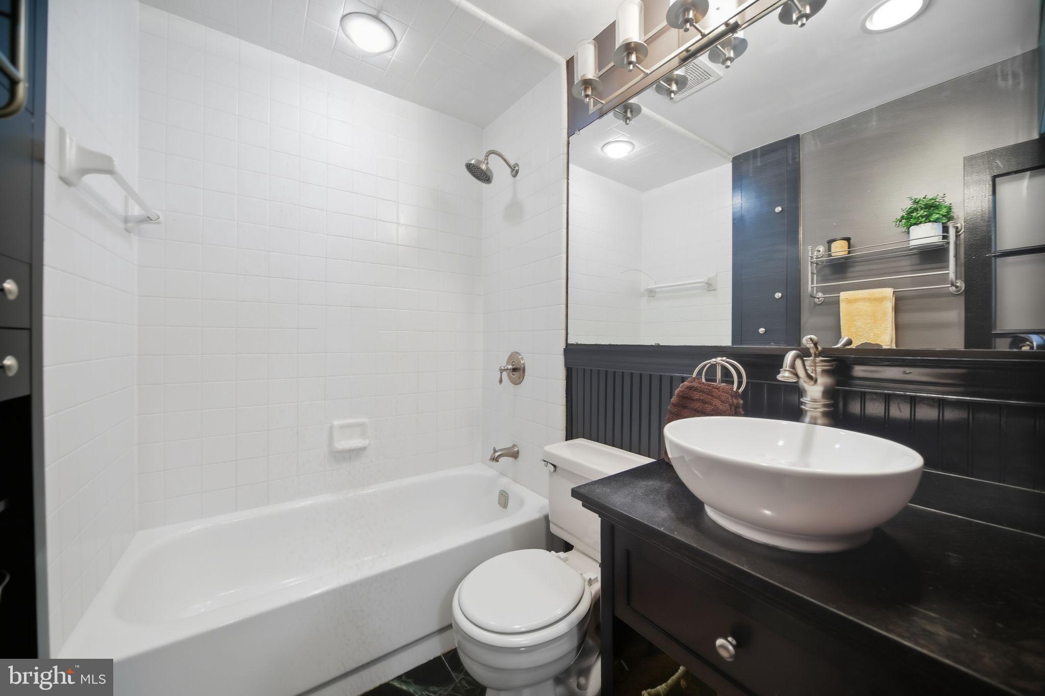 1704 Webster Street Philadelphia, PA 19146 - Photo 16 of 20 a bathroom with a sink a toilet a mirror and shower