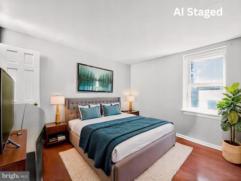 1704 Webster Street Philadelphia, PA 19146 - Photo 5 of 20 a bedroom with a bed and a potted plant