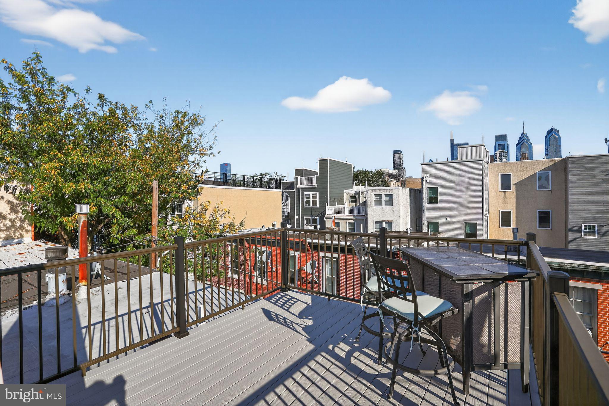 1704 Webster Street Philadelphia, PA 19146 - Photo 8 of 20 a view of a roof deck with table and chairs with wooden floor