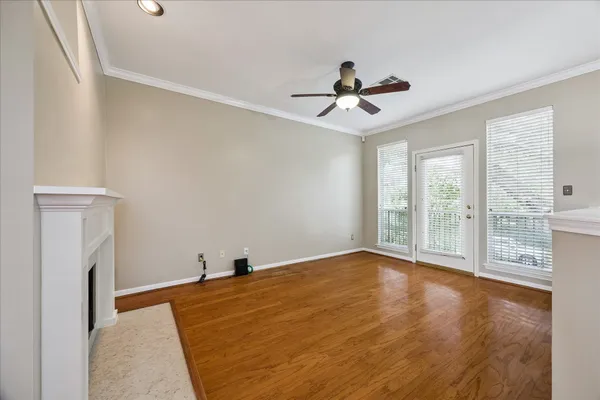 a view of a livingroom with a ceiling fan and window