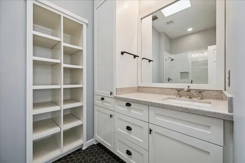 a bathroom with a granite countertop sink mirror and double