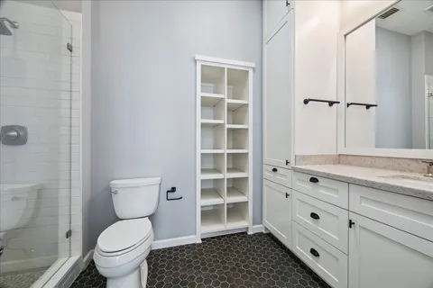 a bathroom with a toilet a sink and shower