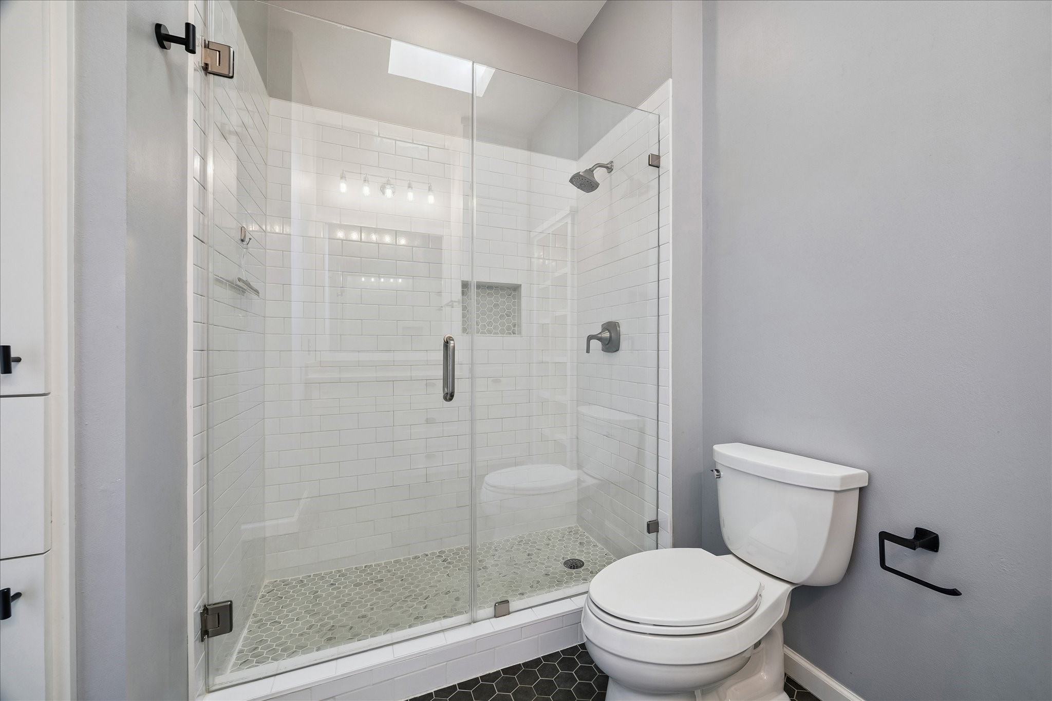 3001 Austin Street Houston, TX 77004 - Photo 15 of 26 This large walk in shower is oversized to give you space and a built in shower niche gives you storage for toiletries.