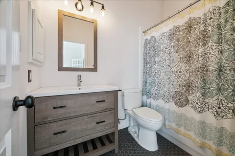 a bathroom with a toilet a sink and a mirror