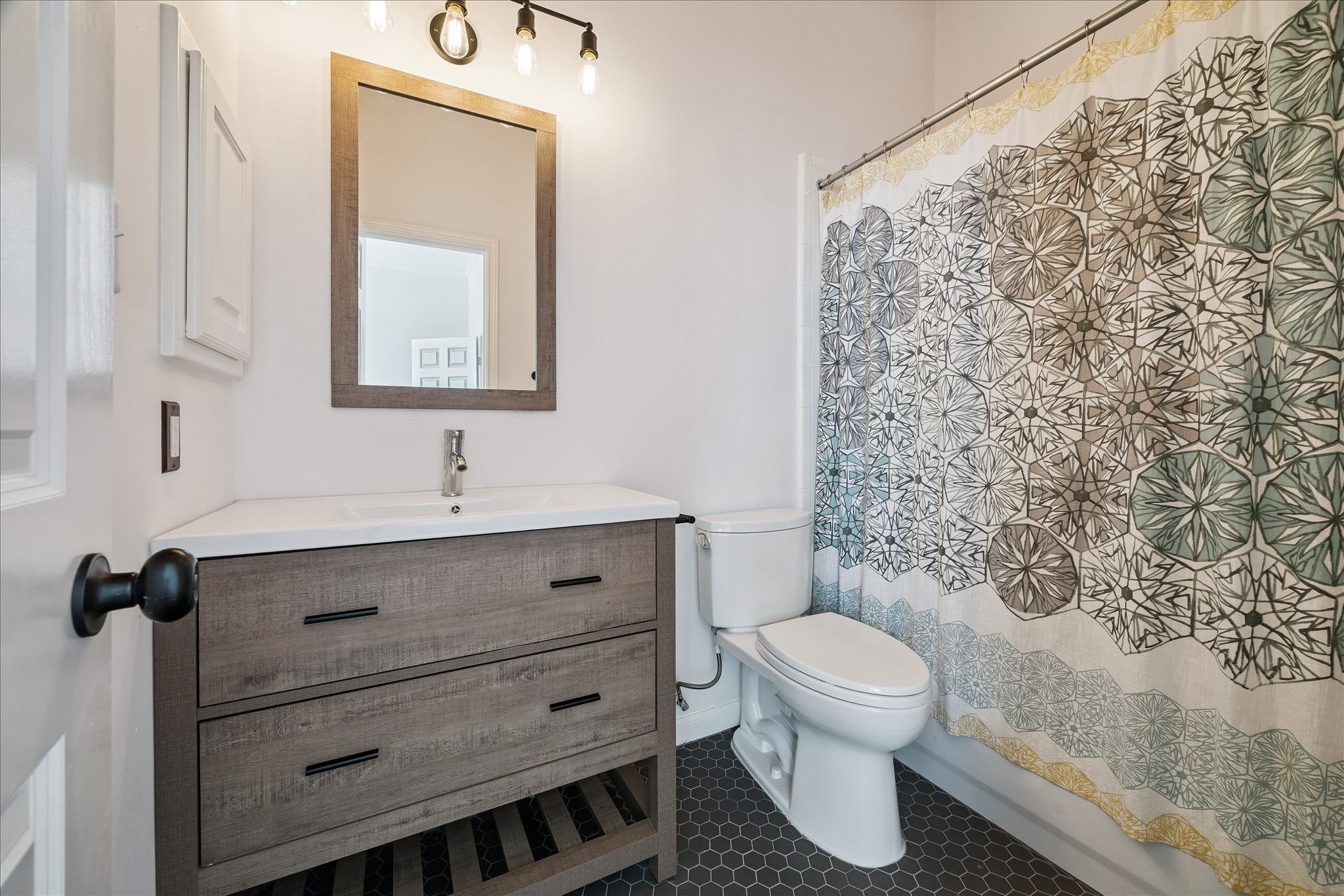 3001 Austin Street Houston, TX 77004 - Photo 19 of 26 Beautiful updated full bath with hexagon tile and tub/shower combo.