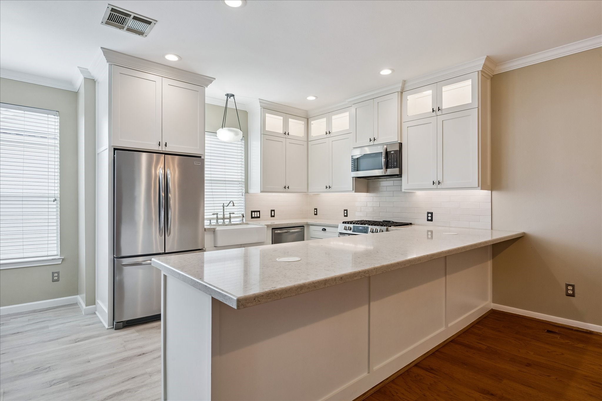 3001 Austin Street Houston, TX 77004 - Photo 5 of 26 Add barstools for casual seating at the kitchen. The upper cabinets light up going all the way to the ceiling adding great storage.