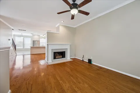 a view of empty room with wooden floor and fireplace