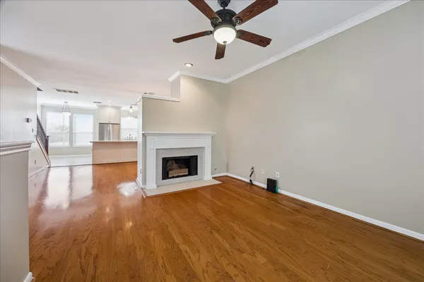 a view of empty room with wooden floor and fireplace