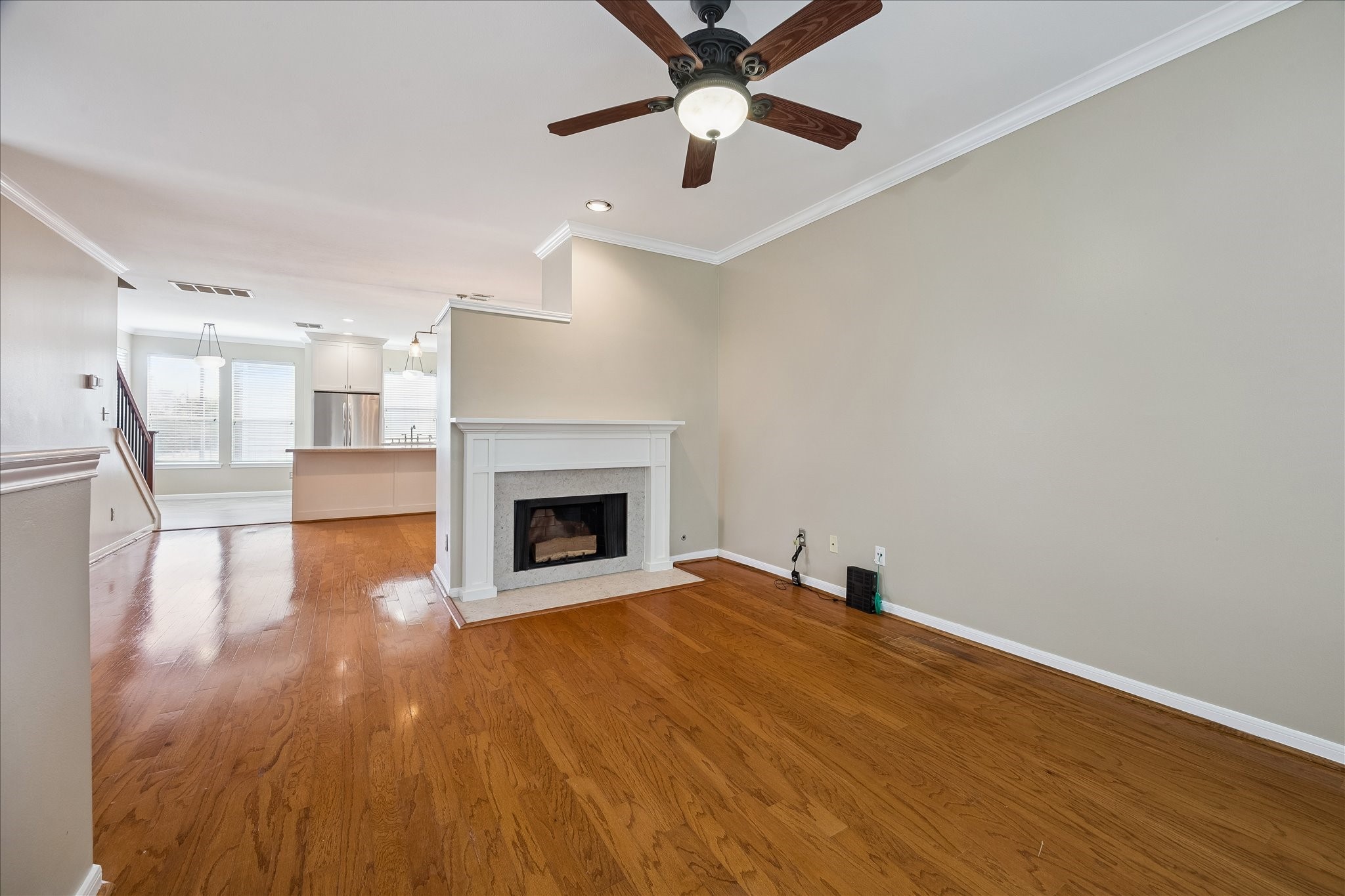 3001 Austin Street Houston, TX 77004 - Photo 9 of 26 Wood floors, crown molding, and a gas fireplace elevate this living room.
