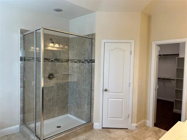 a bathroom with a shower a toilet and a shower