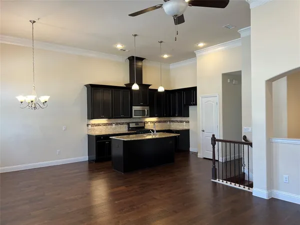 a view of kitchen with microwave and cabinets