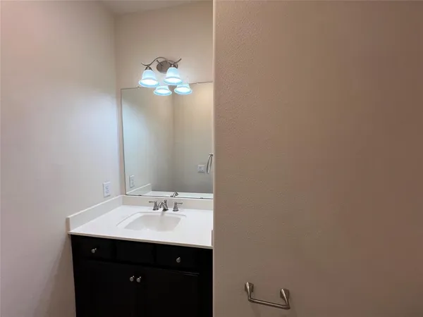 a view of an empty room with wooden floor and closet