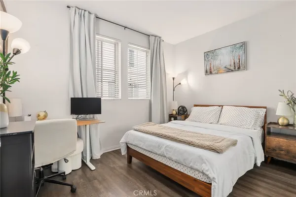 a bedroom with a bed and a desk