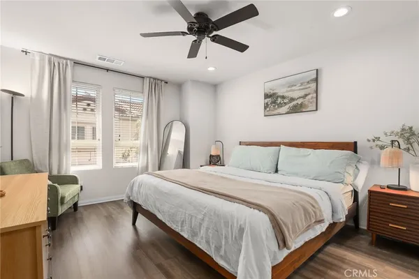 a bedroom with a bed and a large window