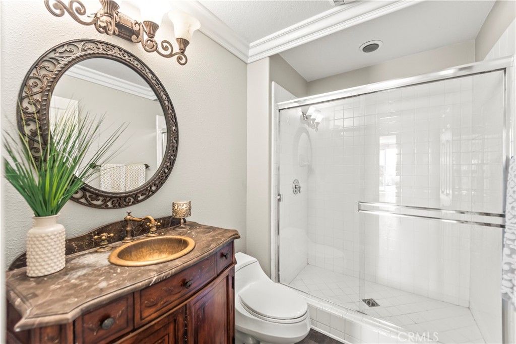 51 Rolling Ridge Rancho Santa Margarita, CA 92688 - Photo 19 of 61 a bathroom with a sink a mirror a toilet and a shower