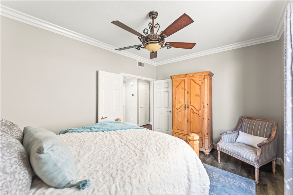 51 Rolling Ridge Rancho Santa Margarita, CA 92688 - Photo 20 of 61 a bedroom with a bed and a chandelier