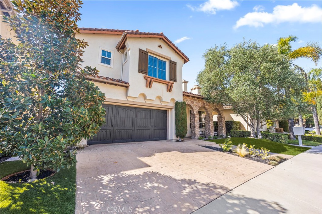 51 Rolling Ridge Rancho Santa Margarita, CA 92688 - Photo 2 of 61 a front view of a house with a yard and garage