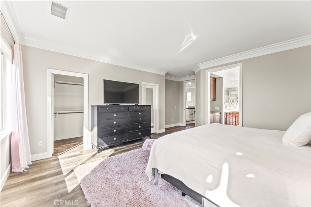 51 Rolling Ridge Rancho Santa Margarita, CA 92688 - Photo 23 of 61 a spacious bedroom with a bed and a flat screen tv