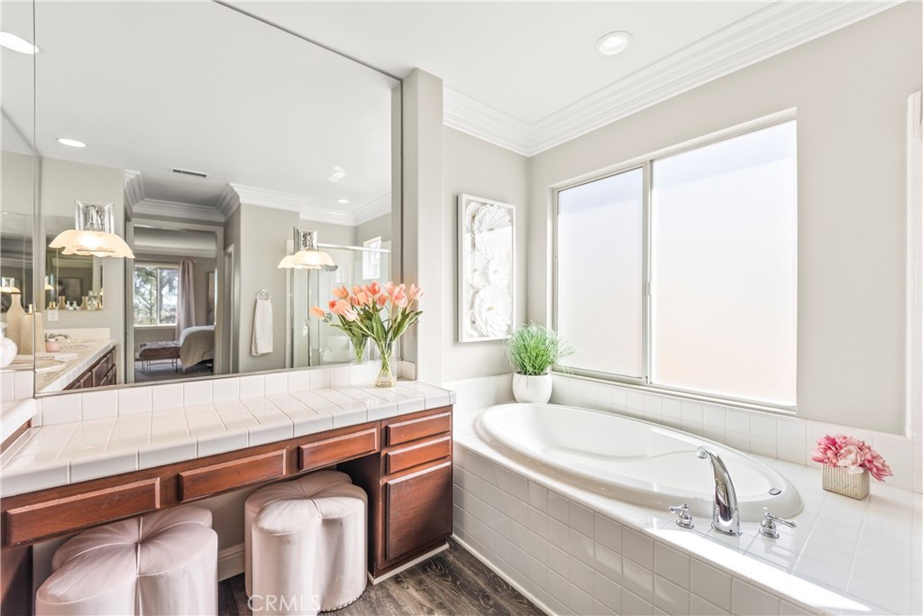 51 Rolling Ridge Rancho Santa Margarita, CA 92688 - Photo 27 of 61 a bathroom with a granite countertop sink and a bathtub