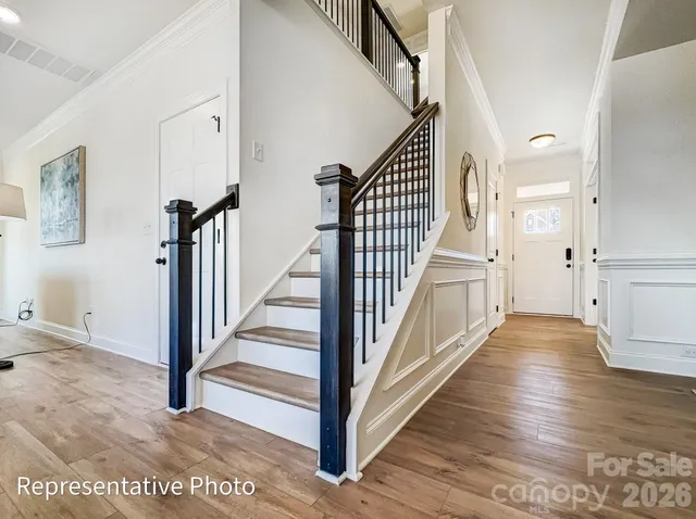a view of a hallway with wooden floor and entryway
