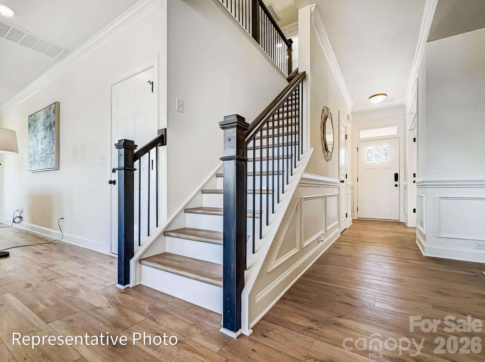 2608 Wild Azalea Court Monroe, NC 28110 - Photo 14 of 26 a view of a hallway with wooden floor and entryway