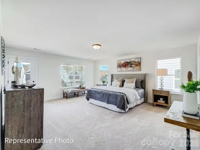 a spacious bedroom with a bed and a couch