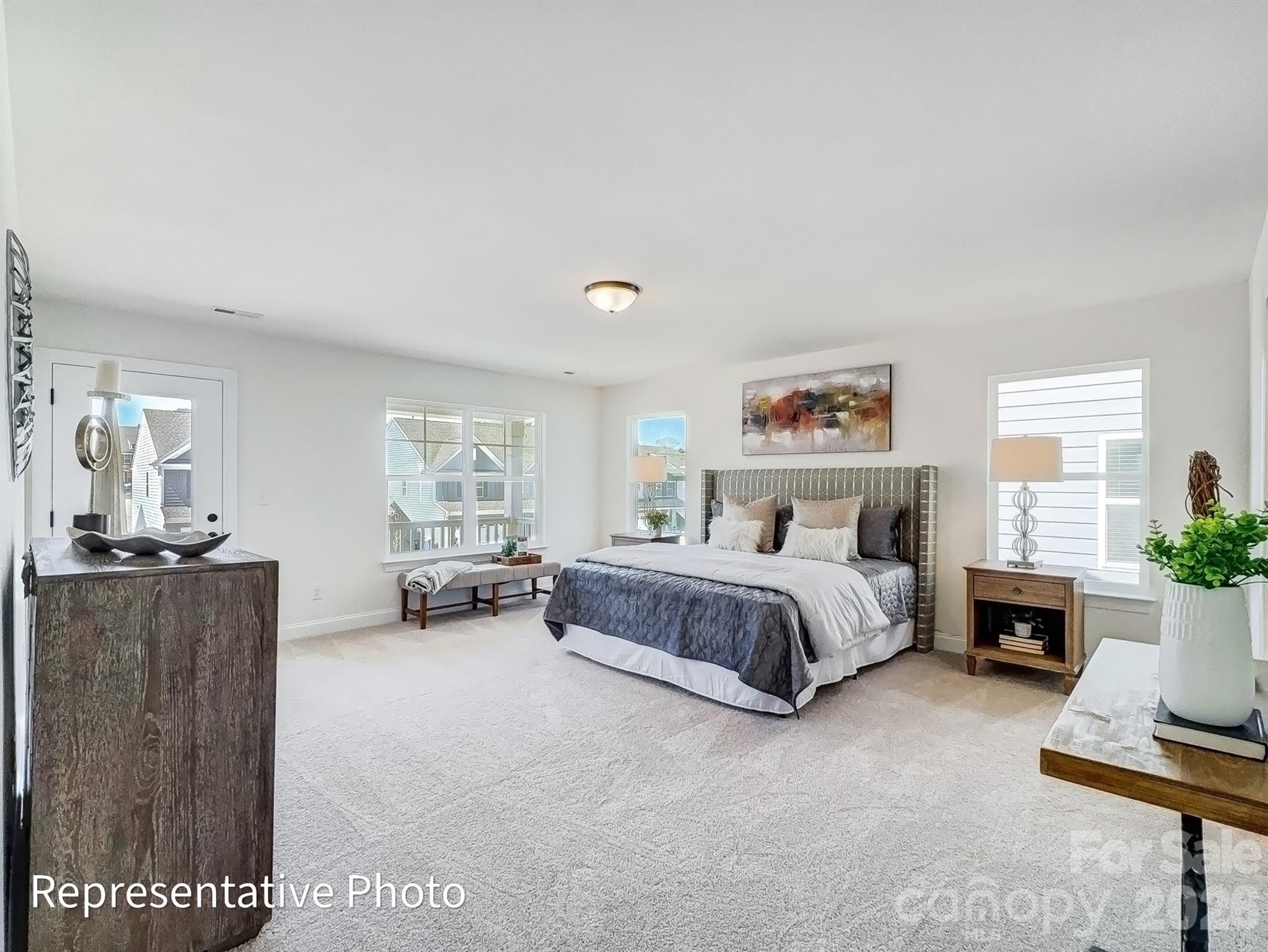 2608 Wild Azalea Court Monroe, NC 28110 - Photo 17 of 26 a spacious bedroom with a bed and a couch