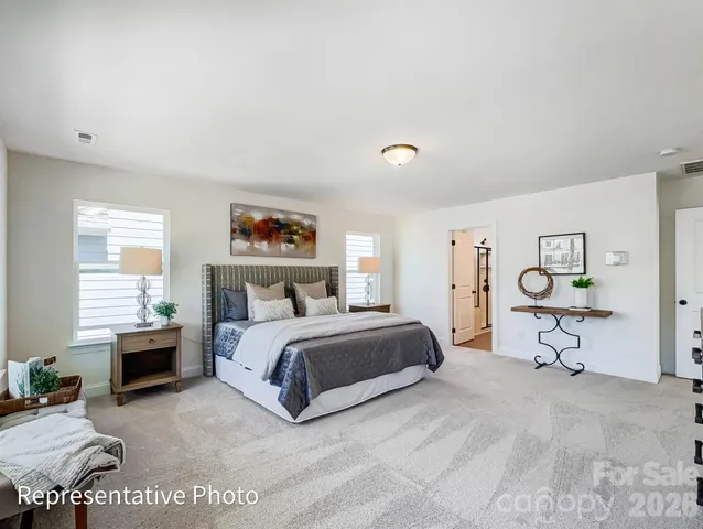 a spacious bedroom with a bed and a window