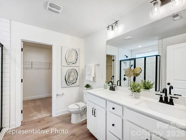a spacious bathroom with a toilet a sink and a large mirror