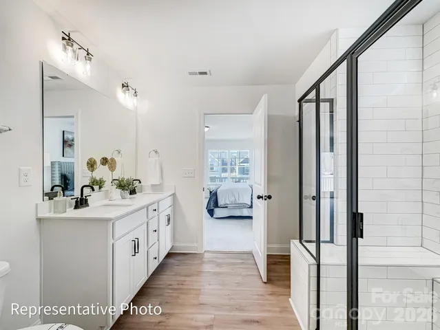 a bathroom with a double vanity sink and mirror