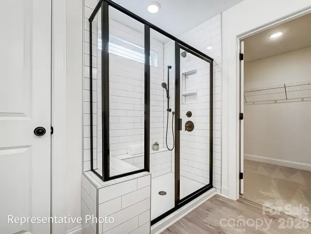 a bathroom with a glass shower door and a sink