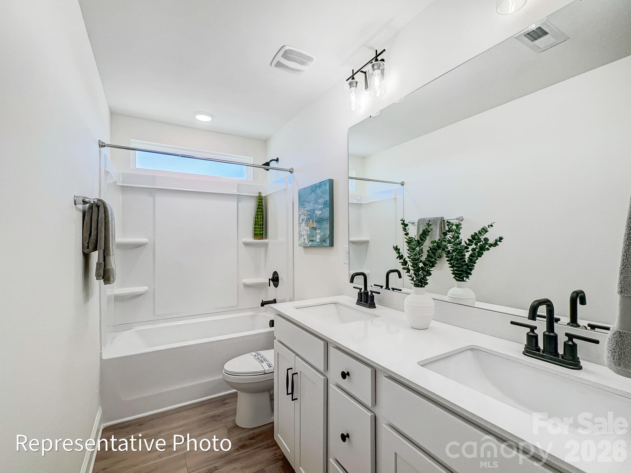 2608 Wild Azalea Court Monroe, NC 28110 - Photo 25 of 26 a bathroom with a sink a toilet and shower