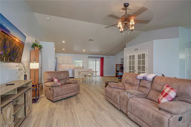 a living room with fireplace furniture and a flat screen tv