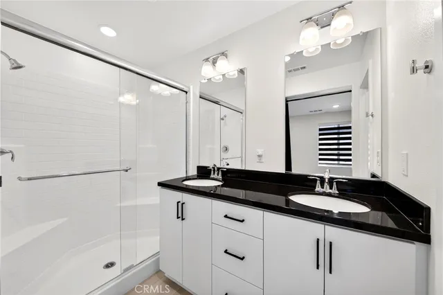 a bathroom with a granite countertop sink a toilet and a mirror