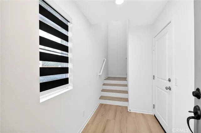 a kitchen with stainless steel appliances granite countertop a sink a stove and a wooden floors