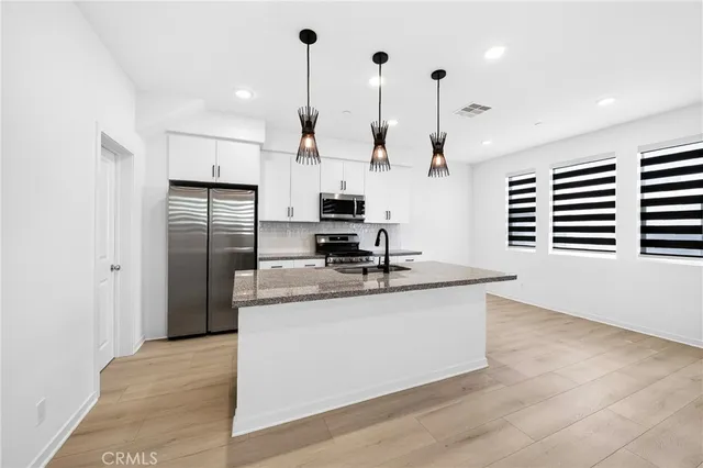 a view of a room with a window and wooden floor