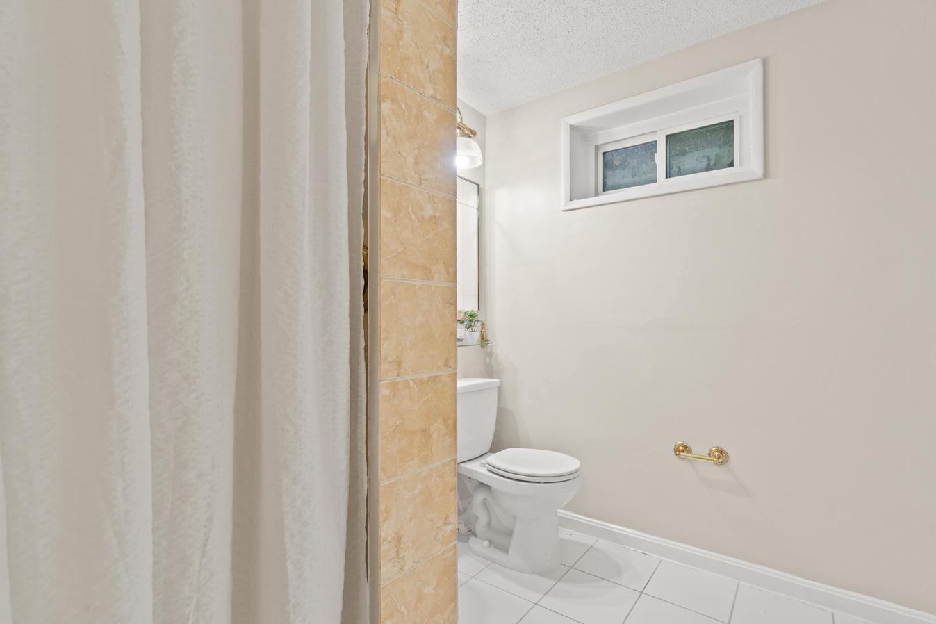 6505 Farley Street Springfield, VA 22152 - Photo 28 of 30 a bathroom with a toilet and a shower