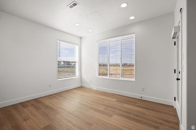 1661 West Ross Road Syracuse, UT 84075 - Photo 10 of 28 Spare room featuring light wood finished floors and recessed lighting