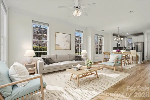 a living room with furniture and wooden floor