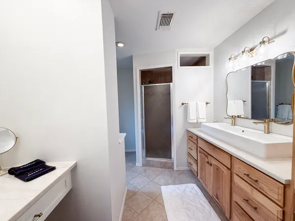 a spacious bathroom with a double vanity sink and a mirror