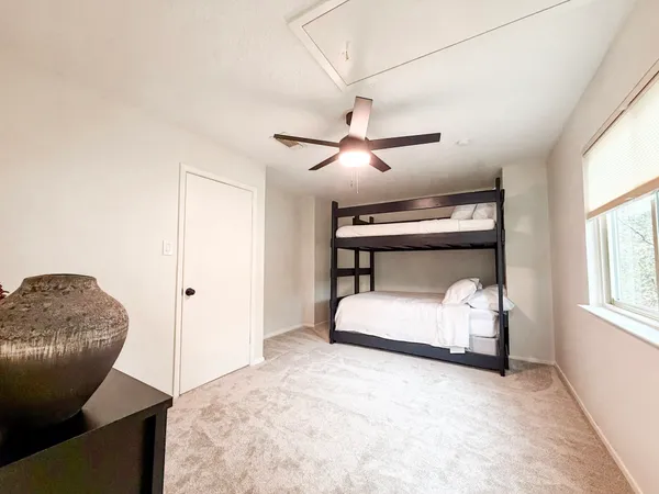 a bedroom with furniture and a window