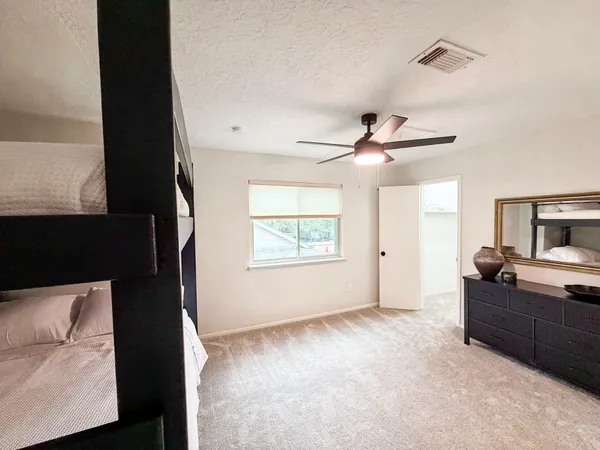 a view of a livingroom with a ceiling fan and window