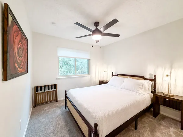 a bedroom with a large bed and a window