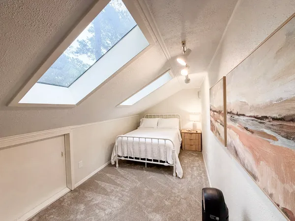 a spacious bedroom with a bed and a window