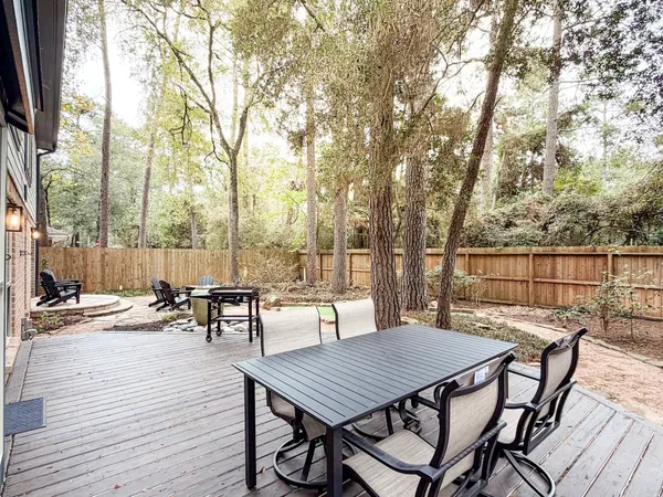 a view of a patio with table and chairs and wooden floor
