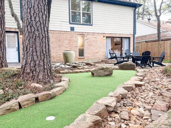 a view of a patio with chairs and plants