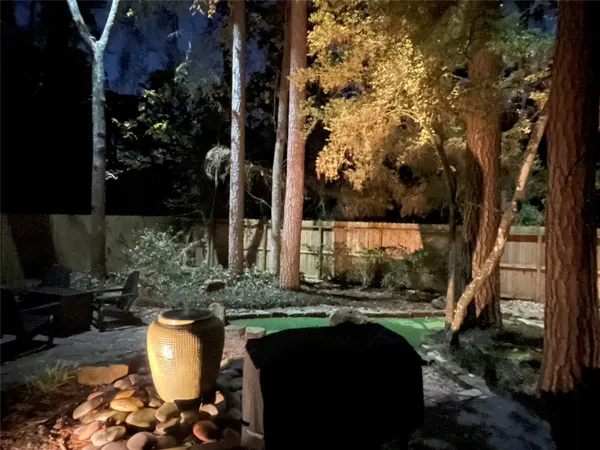 a backyard of a house with table and chairs