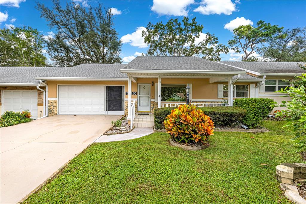8665 Southwest 94 Street, Unit C Ocala, FL 34481 - Photo 1 of 29 a front view of a house with garden