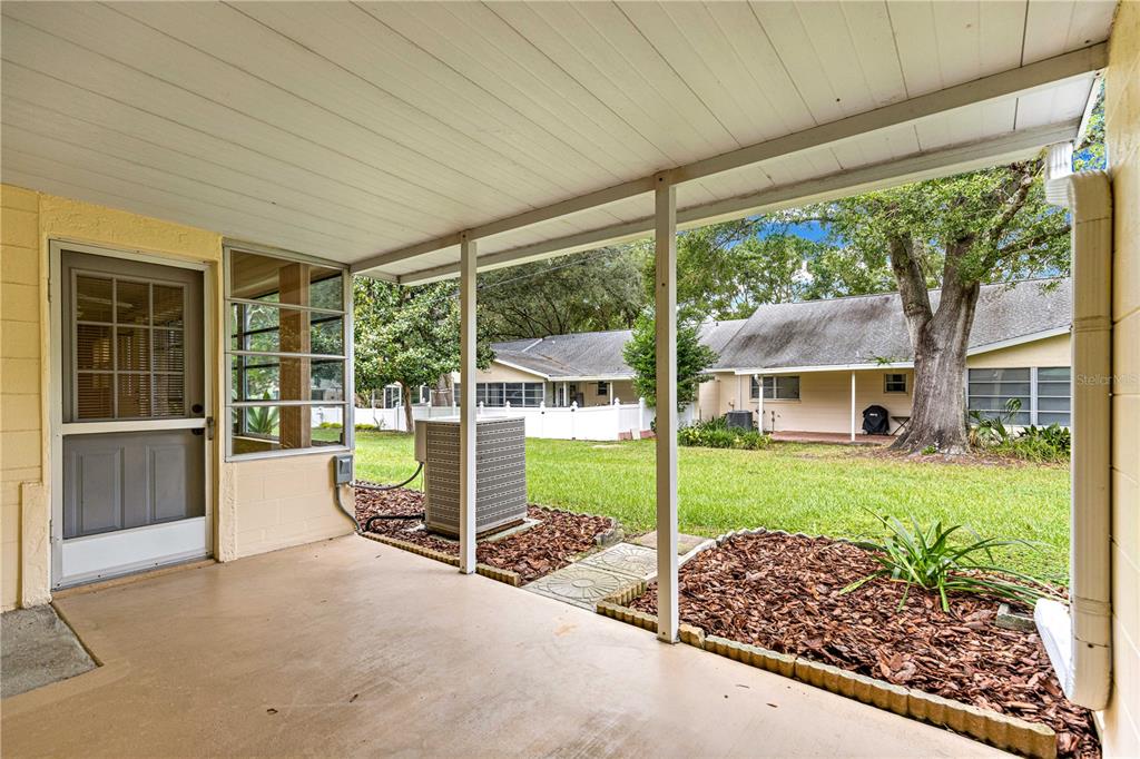 8665 Southwest 94 Street, Unit C Ocala, FL 34481 - Photo 14 of 29 a view of a house with backyard and porch